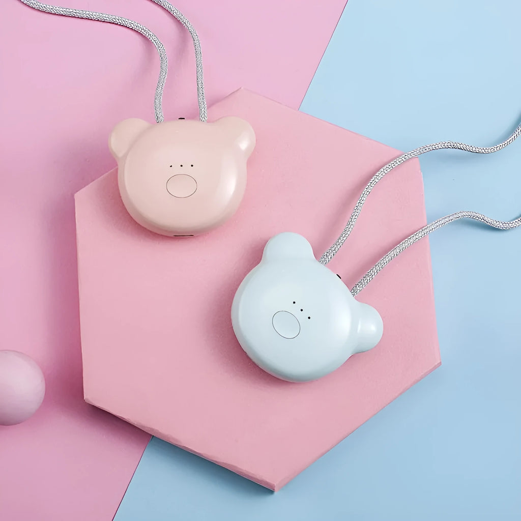 Small pink wearable USB air purifier necklace on a person, showing compact size.