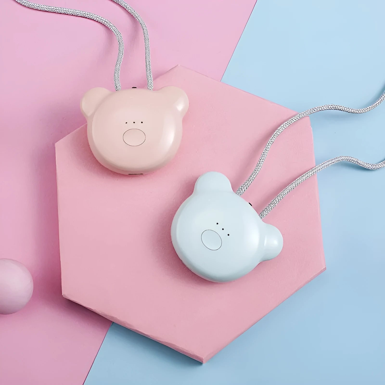 Small pink wearable USB air purifier necklace on a person, showing compact size.