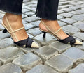 Women's apricot and black colour block stiletto heel sandals with a pointed toe and buckle fastening.