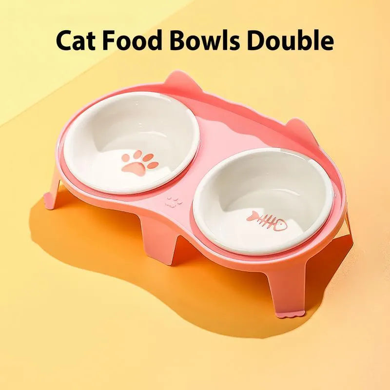 Blue ceramic cat food and water bowls sitting in a white elevated tilted stand with a hook
