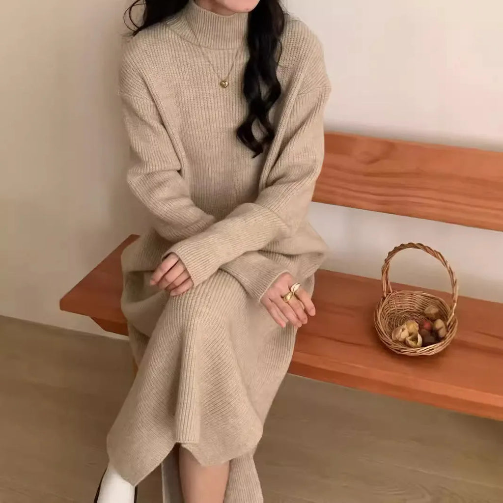 Half turtleneck long sleeve knitted dress with a high waist and mid-length skirt in a solid colour.