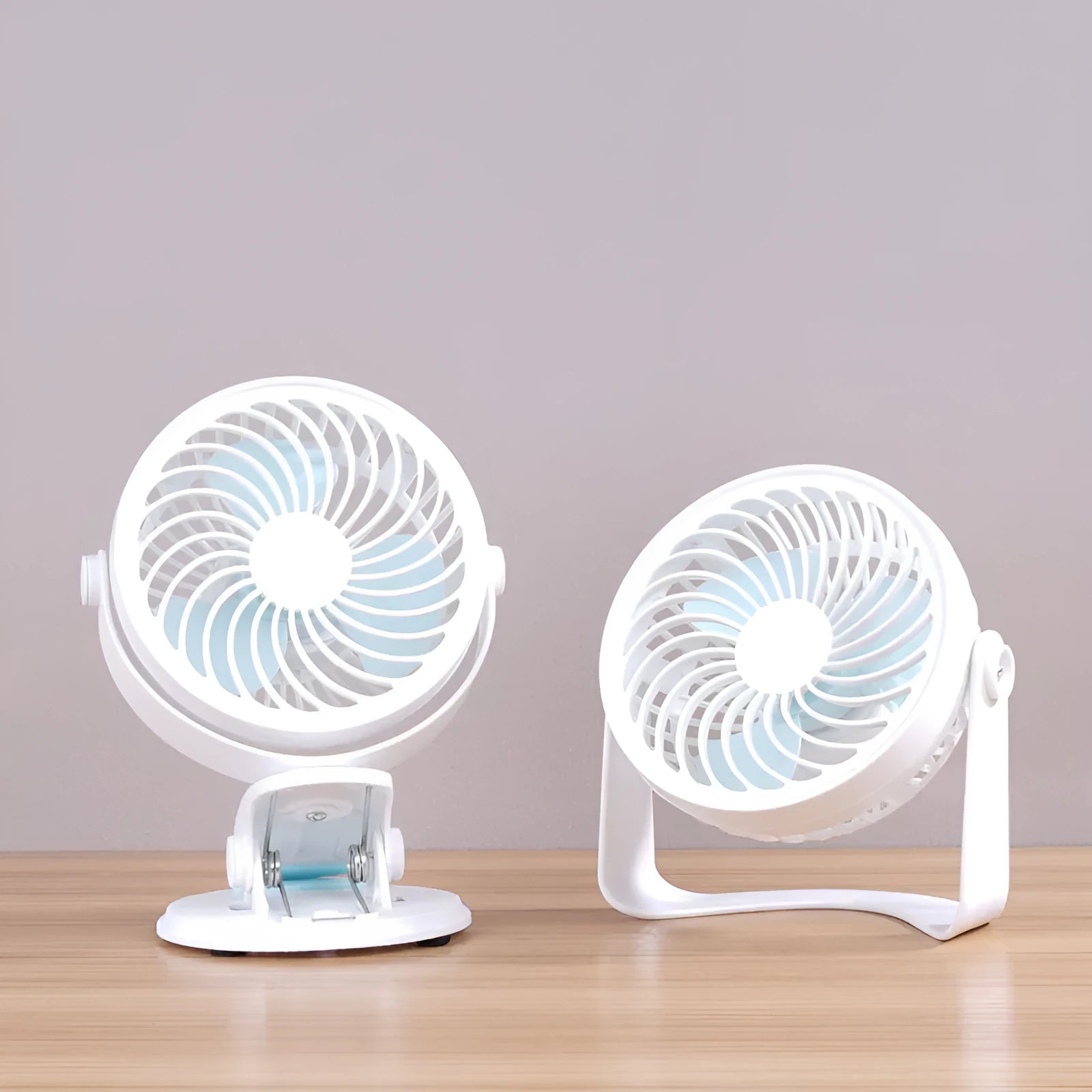 Small USB desk fan with clip attachment and floor stand options in white plastic housing
