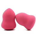 Pink makeup foundation sponge puff on a white background, showing its cubic shape and size.