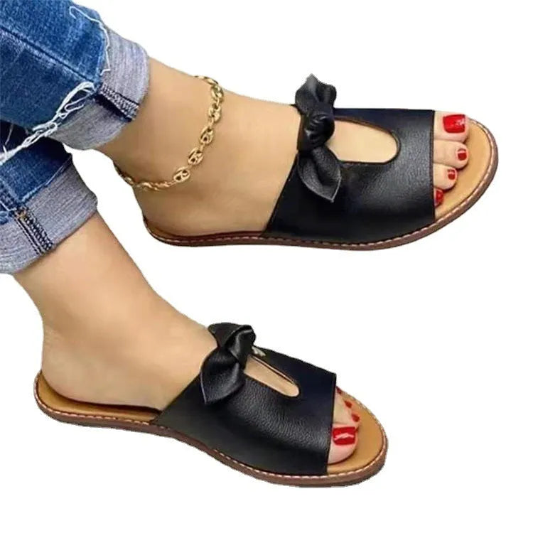 Ladies casual bow sandals in black, pink, or gold colours with fish mouth style and rubber soles.