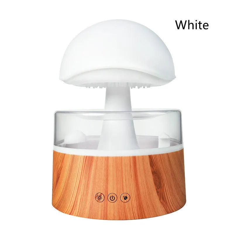 White cloud-shaped humidifier with LED lighting and raindrop simulation on wooden surface