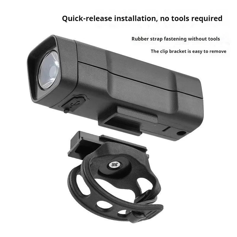 USB rechargeable bicycle headlight mounted on handlebars with quick release strap bracket