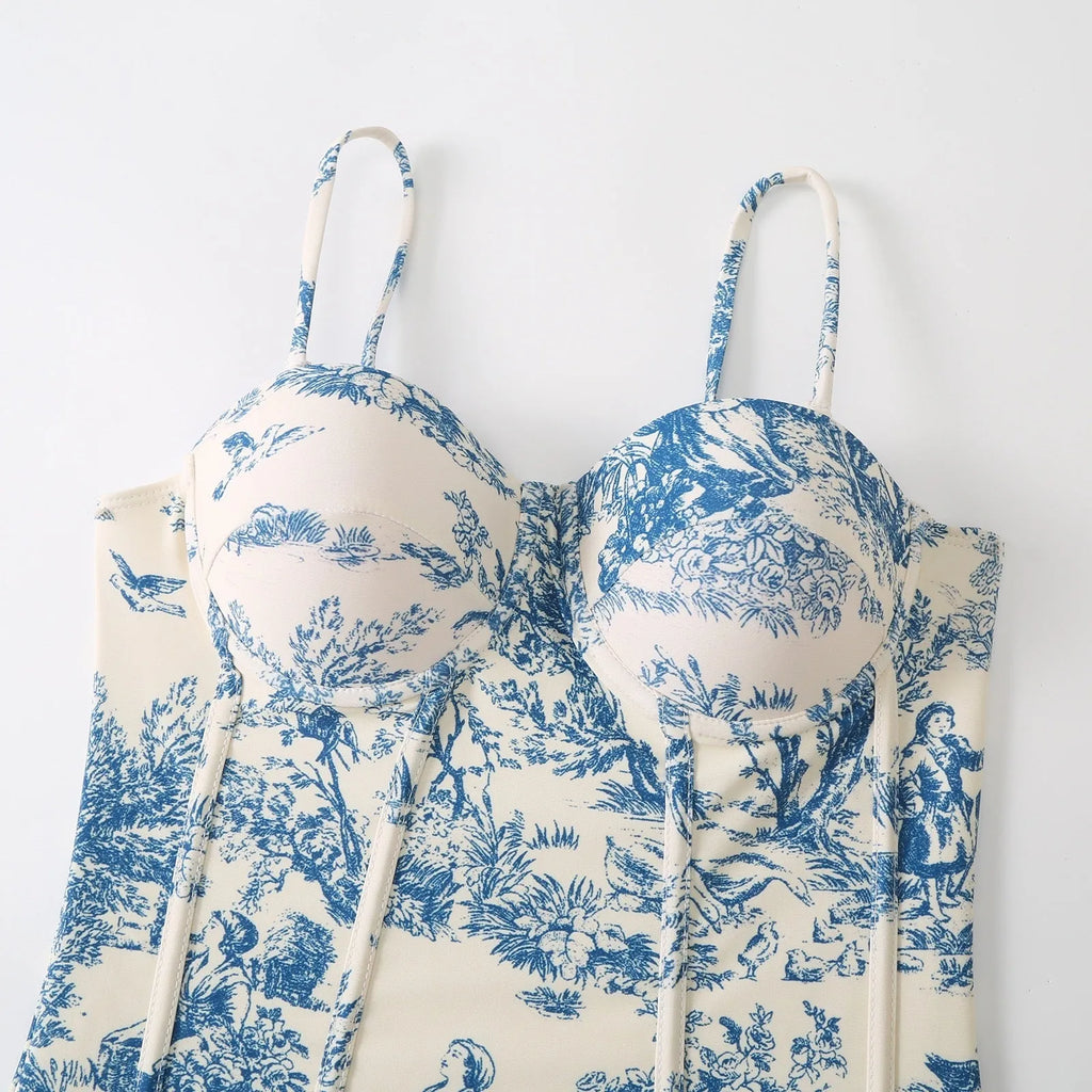 Women's blue one-piece swimsuit set with matching gauze skirt on a size chart
