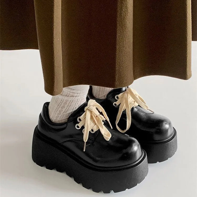 Women's matte black retro lace-up shoes with thick rubber sole and block heel.