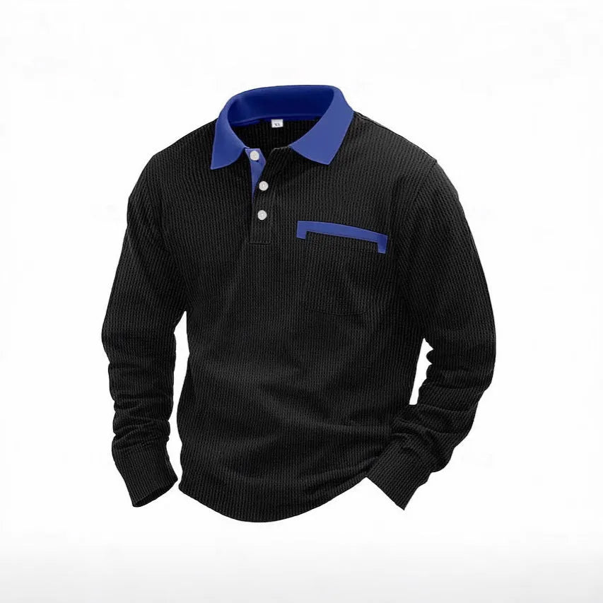 Man wearing a long-sleeved waffle-textured polo shirt in a dark colour with an asymmetric design detail.