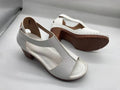 Women's beige peep toe wedge sandals with a buckle ankle strap and low rubber sole.