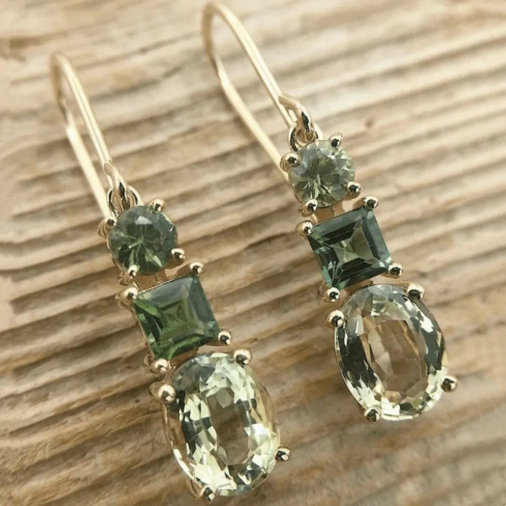 A pair of green geometric quadrilateral earrings made from copper, showing a simple retro bohemian style.