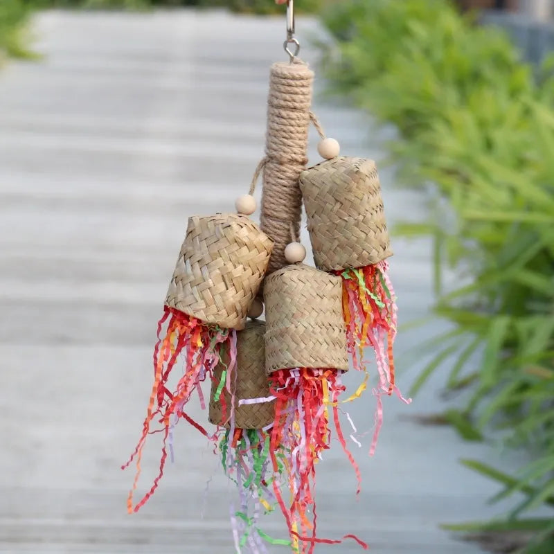Colourful shredded paper hanging bird toy made of wood and sisal for parrots.