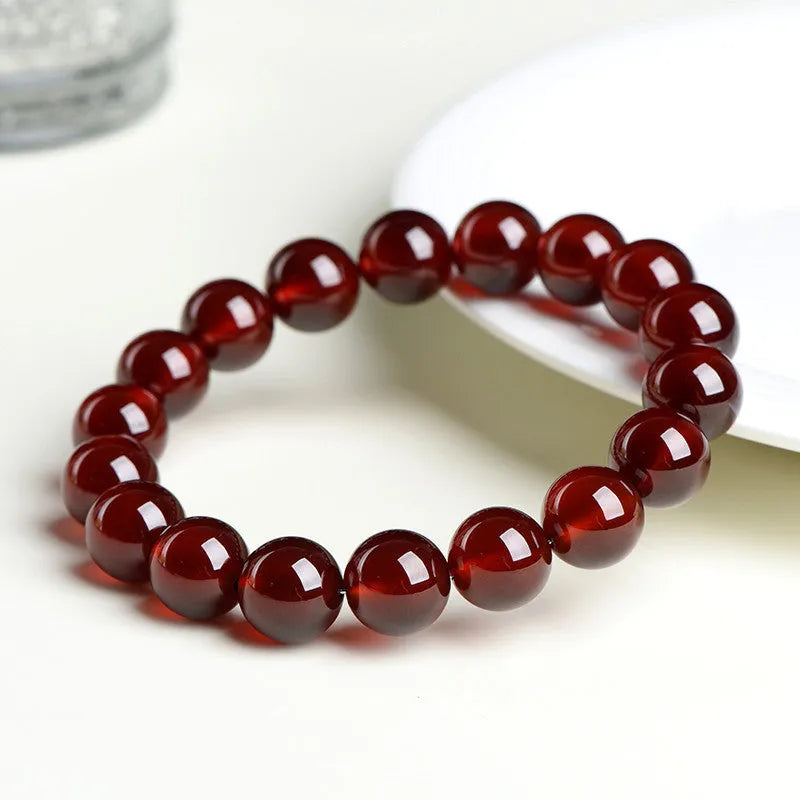 Natural orange red garnet ball bracelet with spherical crystal beads and traditional Ruyi decorative element