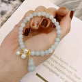 Emerald green jade bracelet with a raised gourd design in a Chinese style.