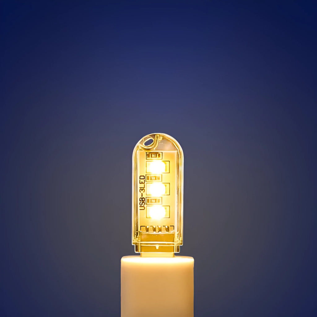 Compact white LED baby night light with USB cable showing warm and white light options