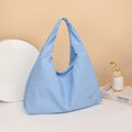 Women's heart-shaped nylon underarm bag in black, blue, khaki, and yellow colour options showing large capacity design