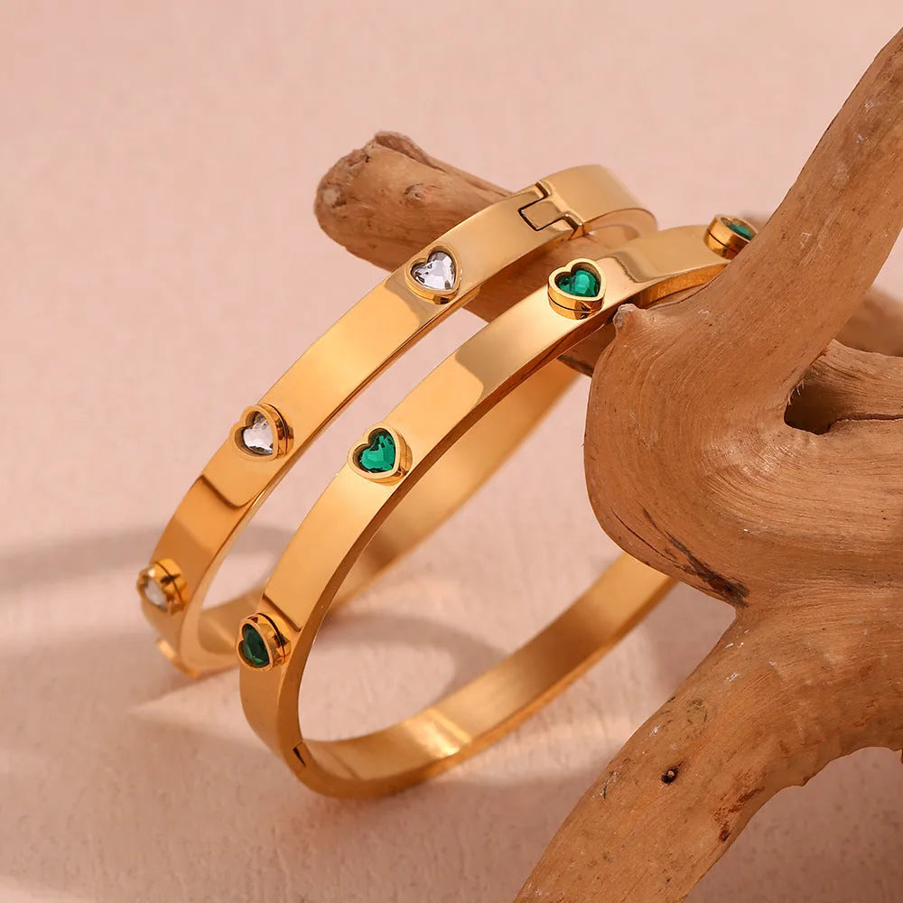 Gold stainless steel women's bracelet with a small micro-inlaid peach heart, shown with green and white diamond accent options.