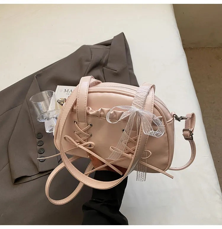 Women's casual shoulder handbag with bandage bow detail in PU material showing internal phone compartment
