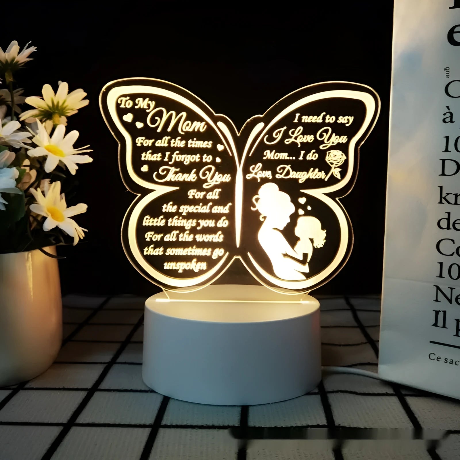 Modern minimalist white heart-shaped table lamp with a touch switch on a wooden table.