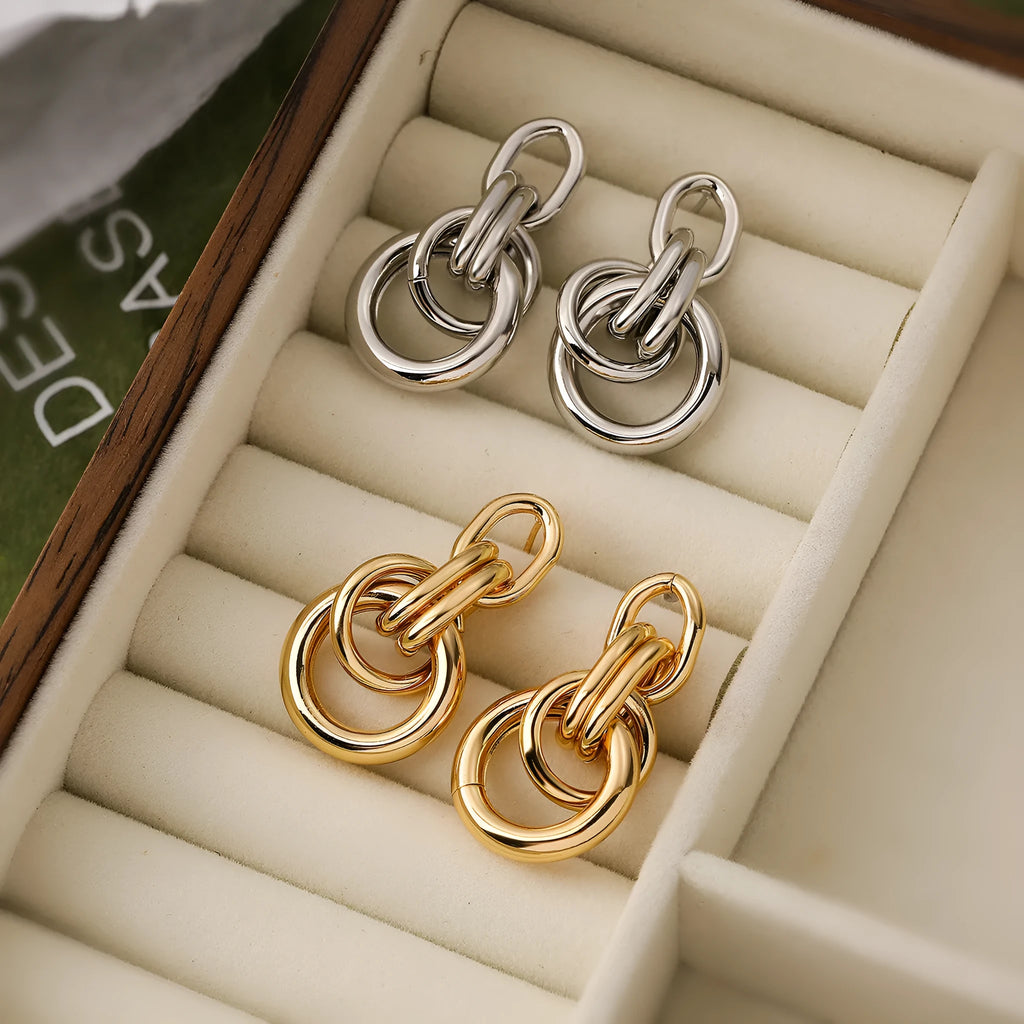 A pair of gold-coloured geometric earrings with an irregular, high-profile wild design for women.