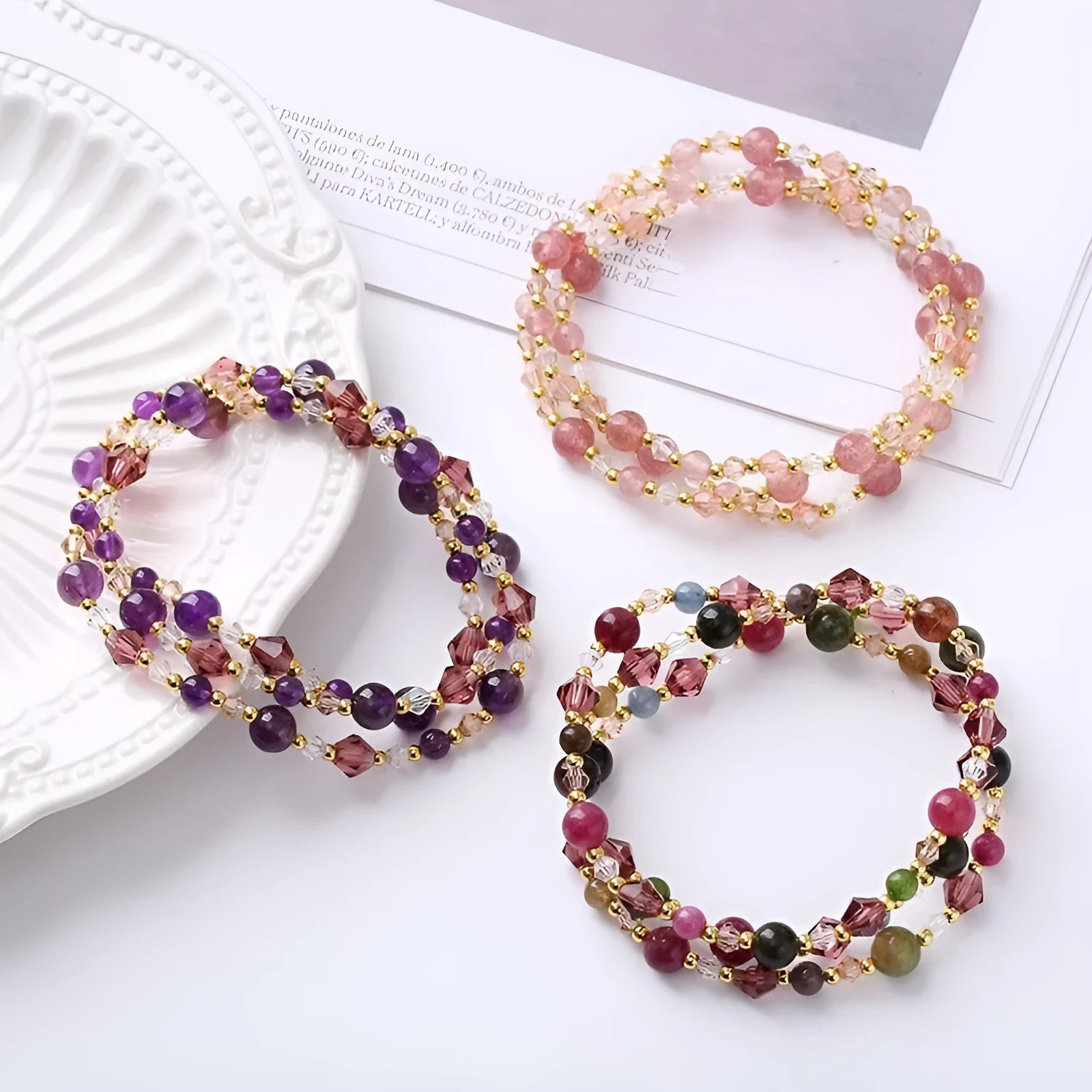 Women's adjustable bracelet with three rings of tourmaline, strawberry quartz, and amethyst crystal beads.