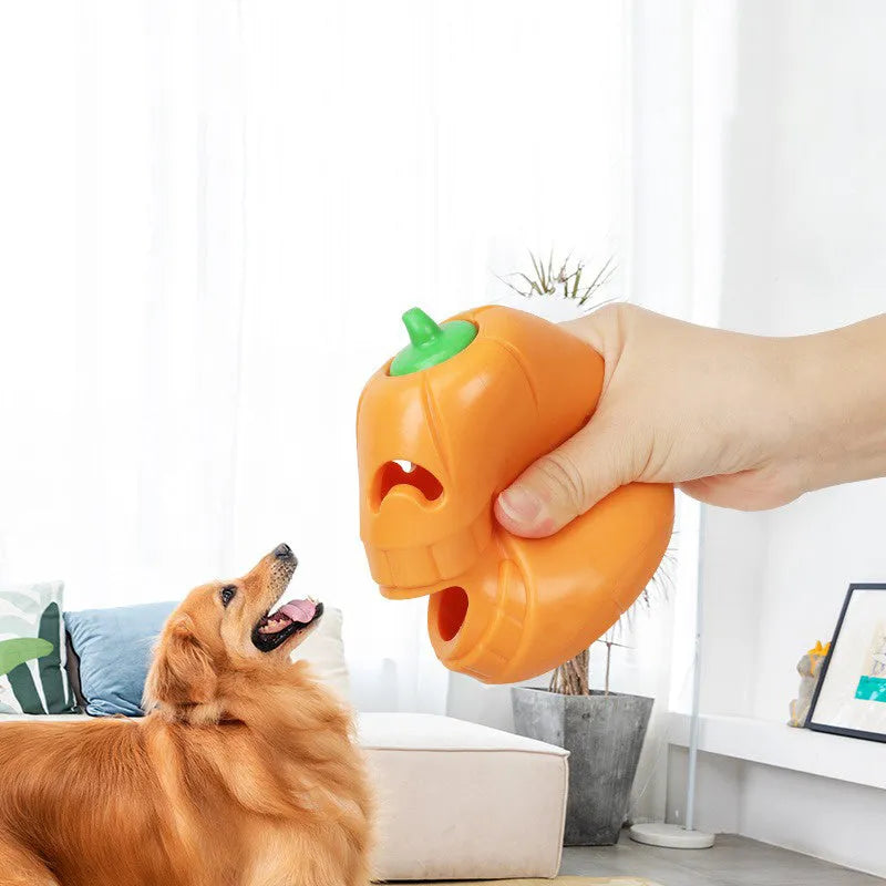 Orange Halloween pumpkin shaped dog chew toy with treat dispensing funnel opening