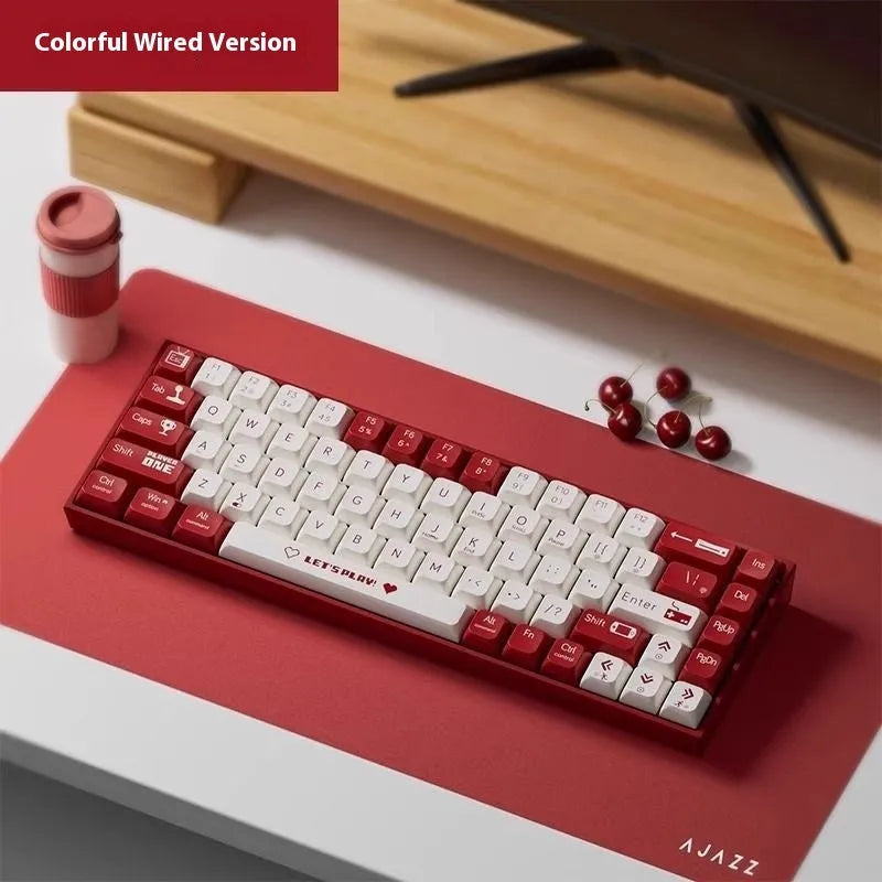 AJAZZ AK680 wired mechanical gaming keyboard with red and white mixed colour keycaps on a desktop.