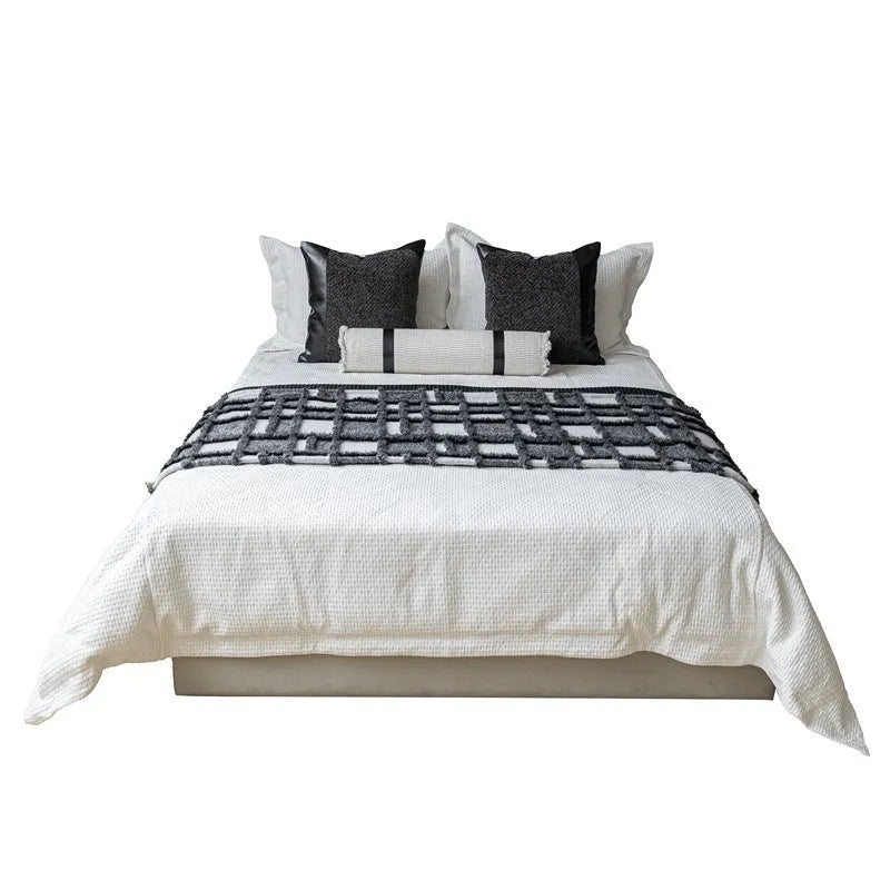 Modern minimalist grey and white plaid polyester bed runner set with pillow on a bed