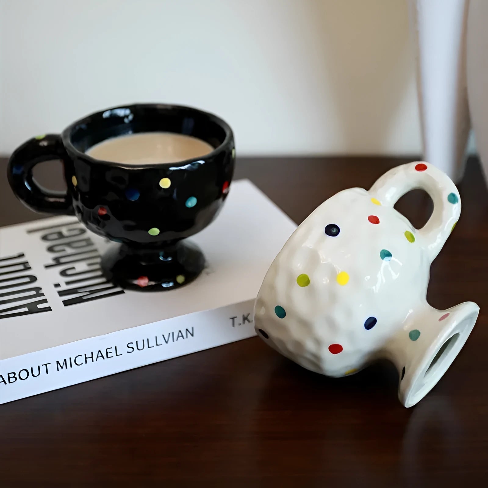 Hand-pinched irregular shaped ceramic mug in a solid colour on a table