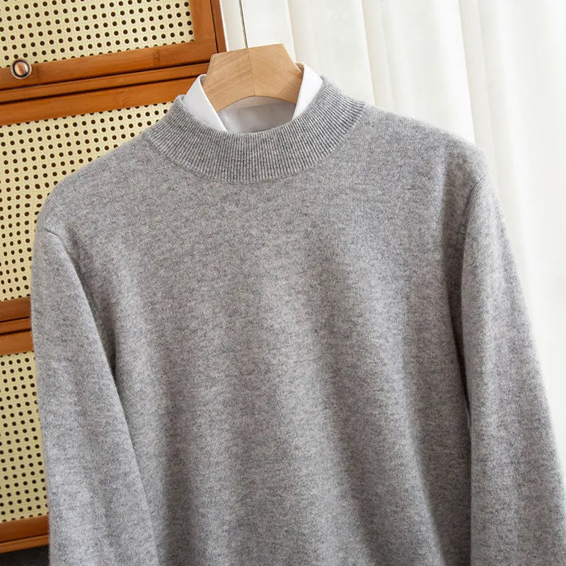 Men's half-turtleneck loose fit wool sweater in a neutral colour on a hanger.