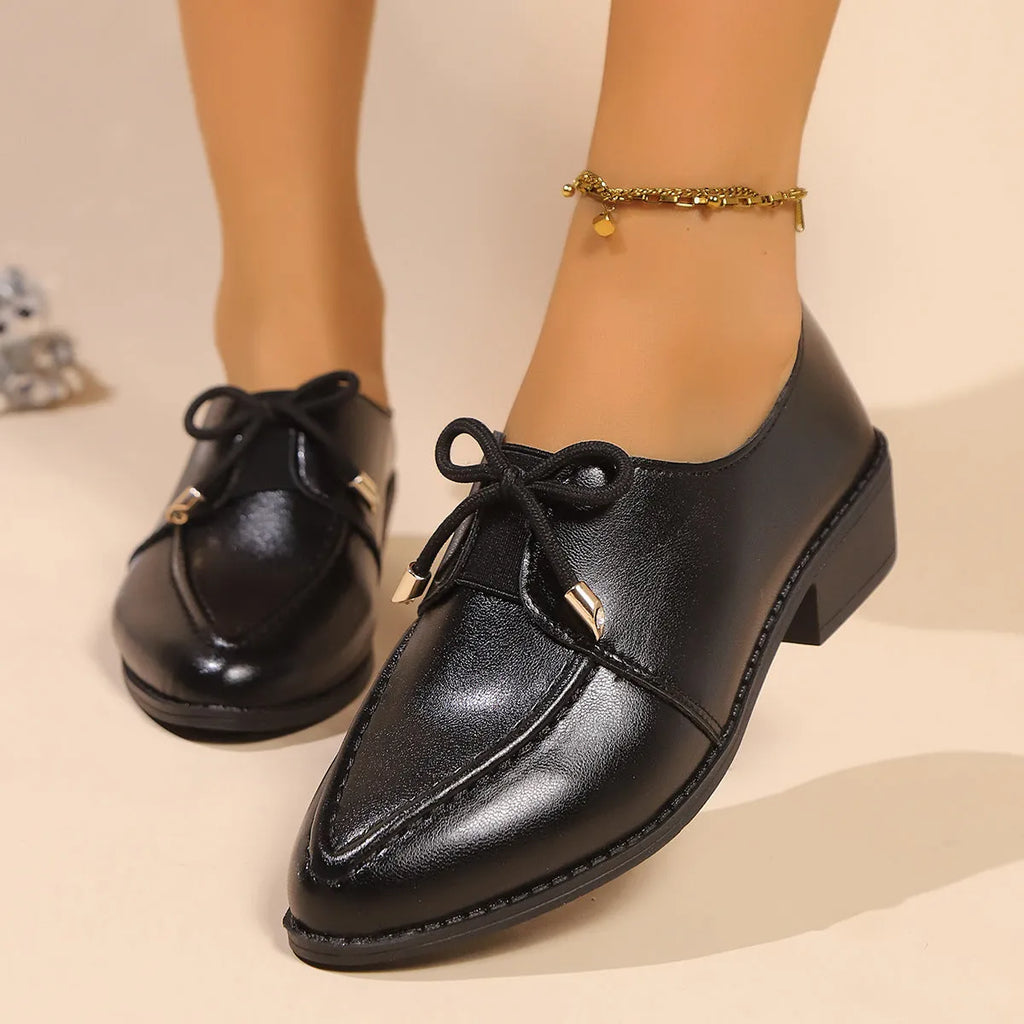 Women's British-style flat shoes with decorative bow, PU upper, and rubber sole in sizes 36-43.
