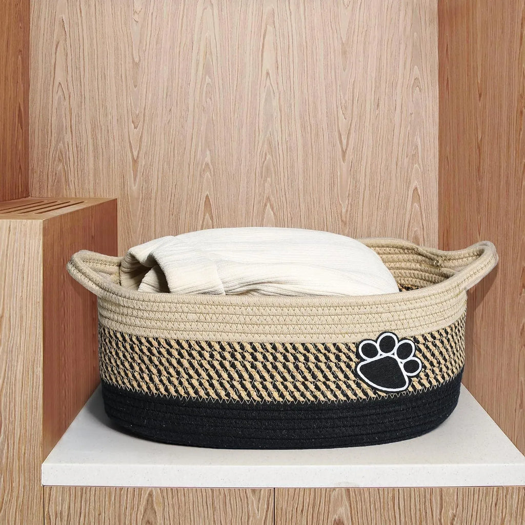 Light beige handmade cotton rope storage basket with wooden details and a handle.