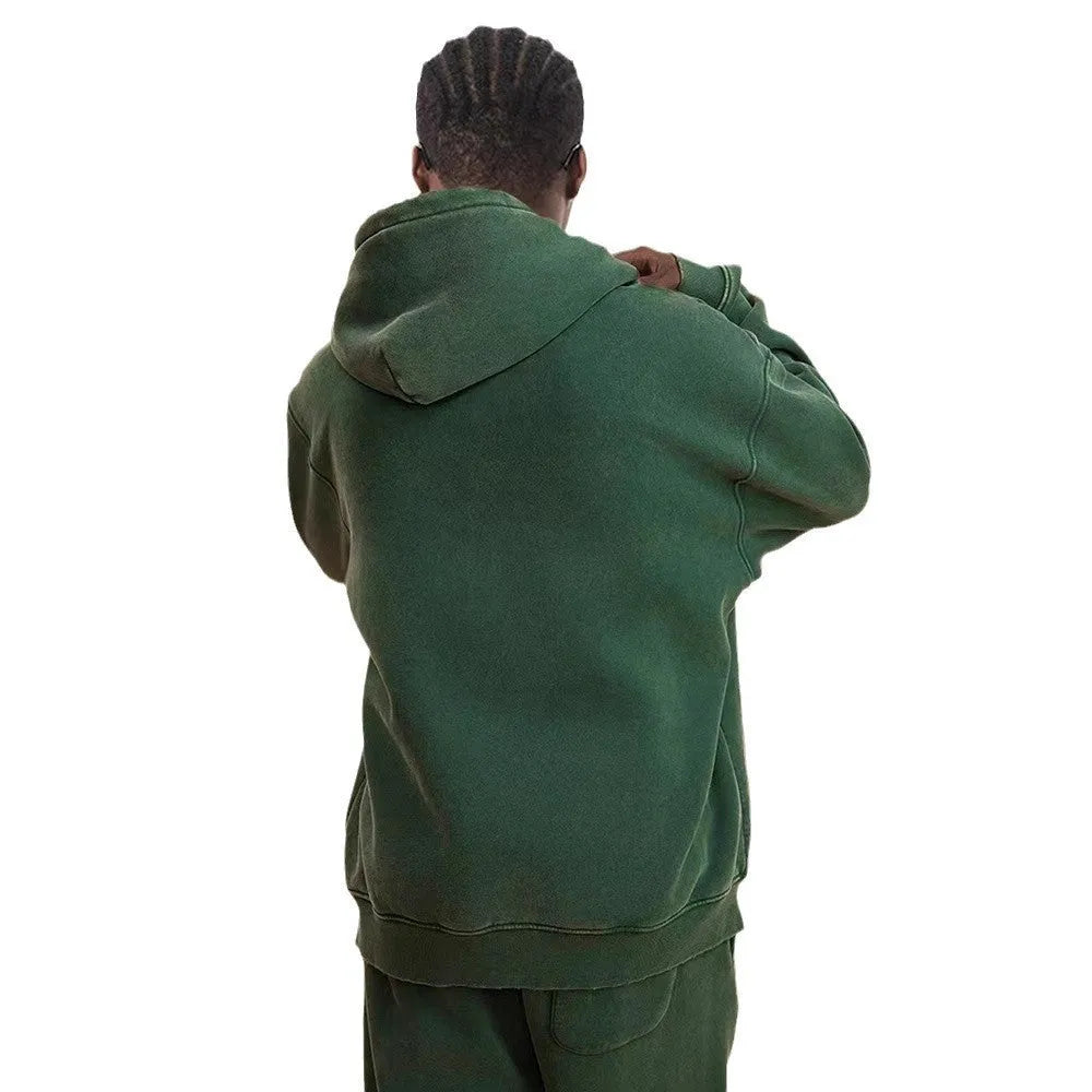 Man wearing a washed black fleece-lined hooded cardigan with a double zipper