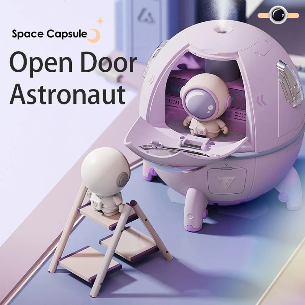 Purple astronaut-shaped USB desktop humidifier with colourful LED light on wooden desk