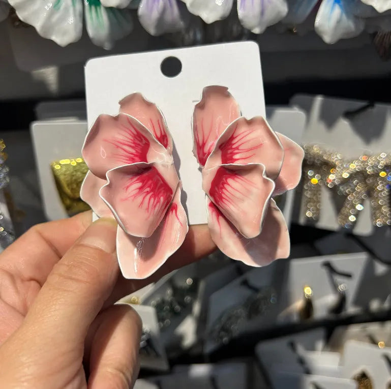 A pair of pastoral style flower stud earrings with an oil-spot glaze finish in an alloy setting.
