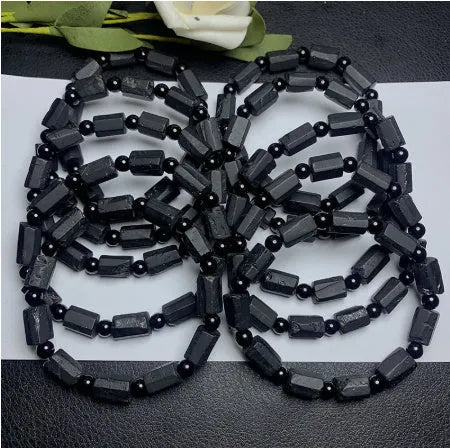 Natural black tourmaline rough stone bracelet with approximately 9mm beads on wrist
