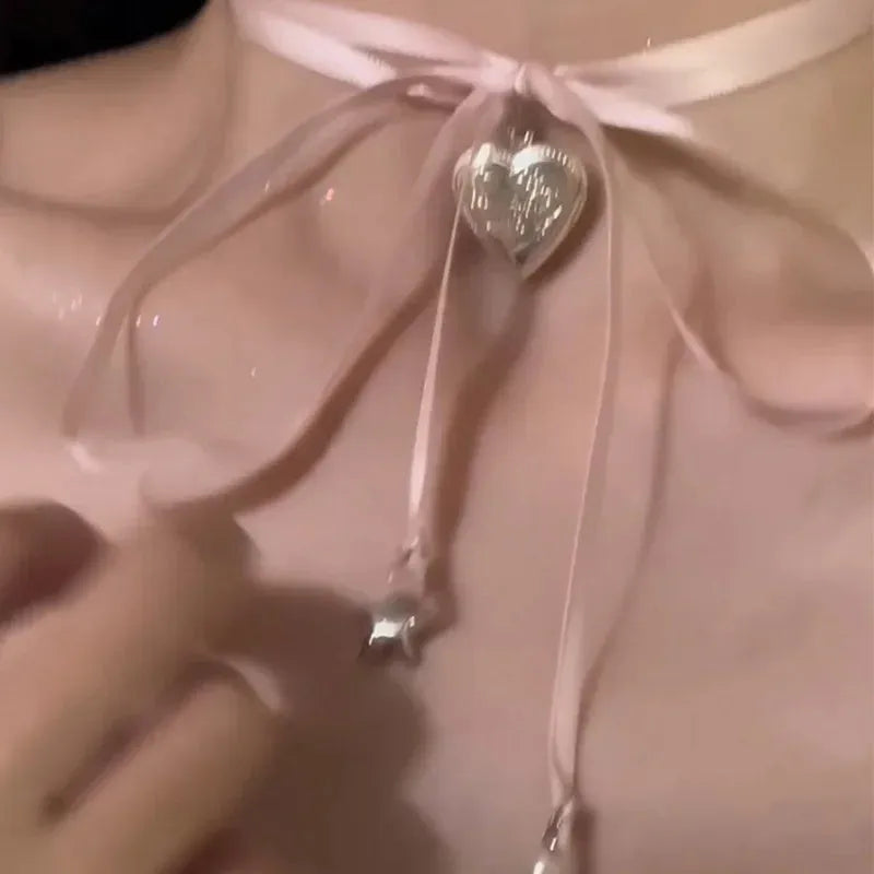 Women's alloy necklace with love pendant and ribbon charm on clavicle chain in electroplated finish