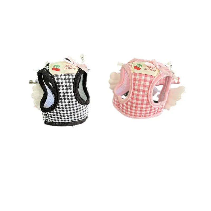 Small dog wearing pink cotton chest and back harness with integrated hand holding rope