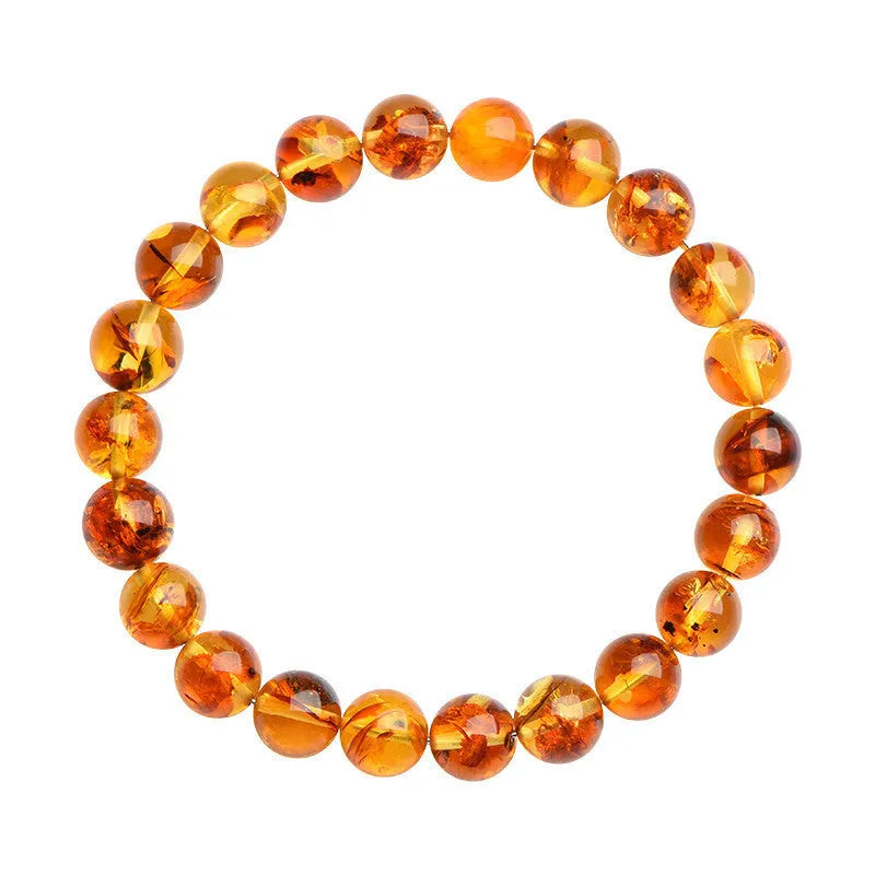 Natural yellow piebald amber beaded bracelet with geometric polished beads on a white background.