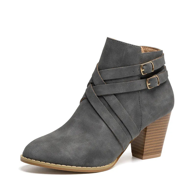 Women's grey ankle boot with a side zipper, buckle detail, and a 7cm rubber heel.