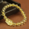 Yellow leather Citrine Pi Xiu bracelet with a clear artificial crystal charm in Chinese simple style.