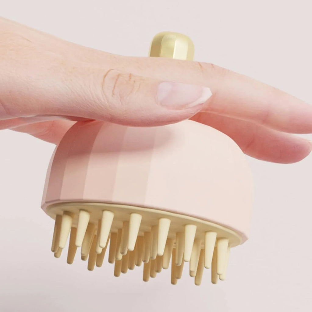 Green silicone double-sided pet bath massage brush with soft bristles on a bathroom counter.
