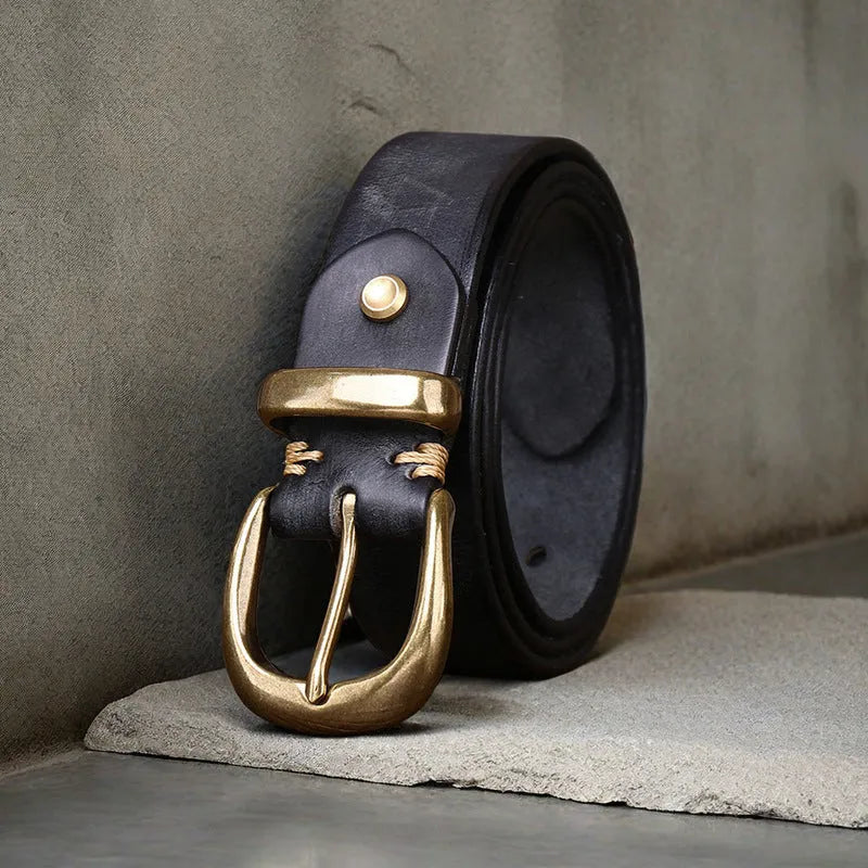 Men's black cattlehide leather belt with copper pin buckle on a pair of jeans