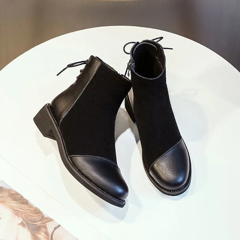 Women's black Martin boots with side zipper, round toe, and knee-length design