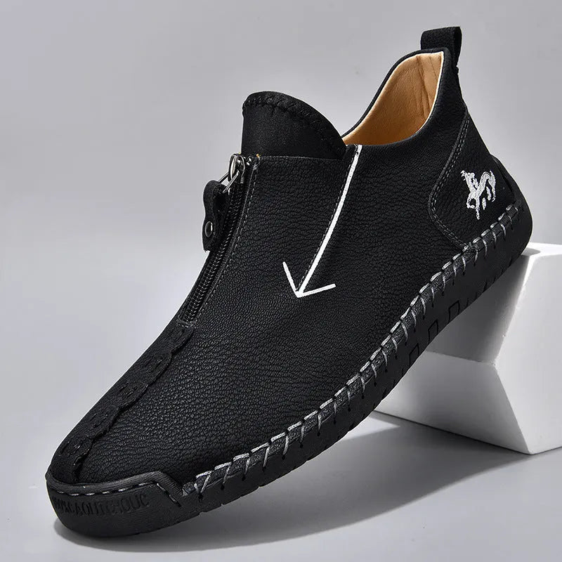 Men's black front-zipper casual leather-style boots with round toe and hand-stitched detail on a white background.
