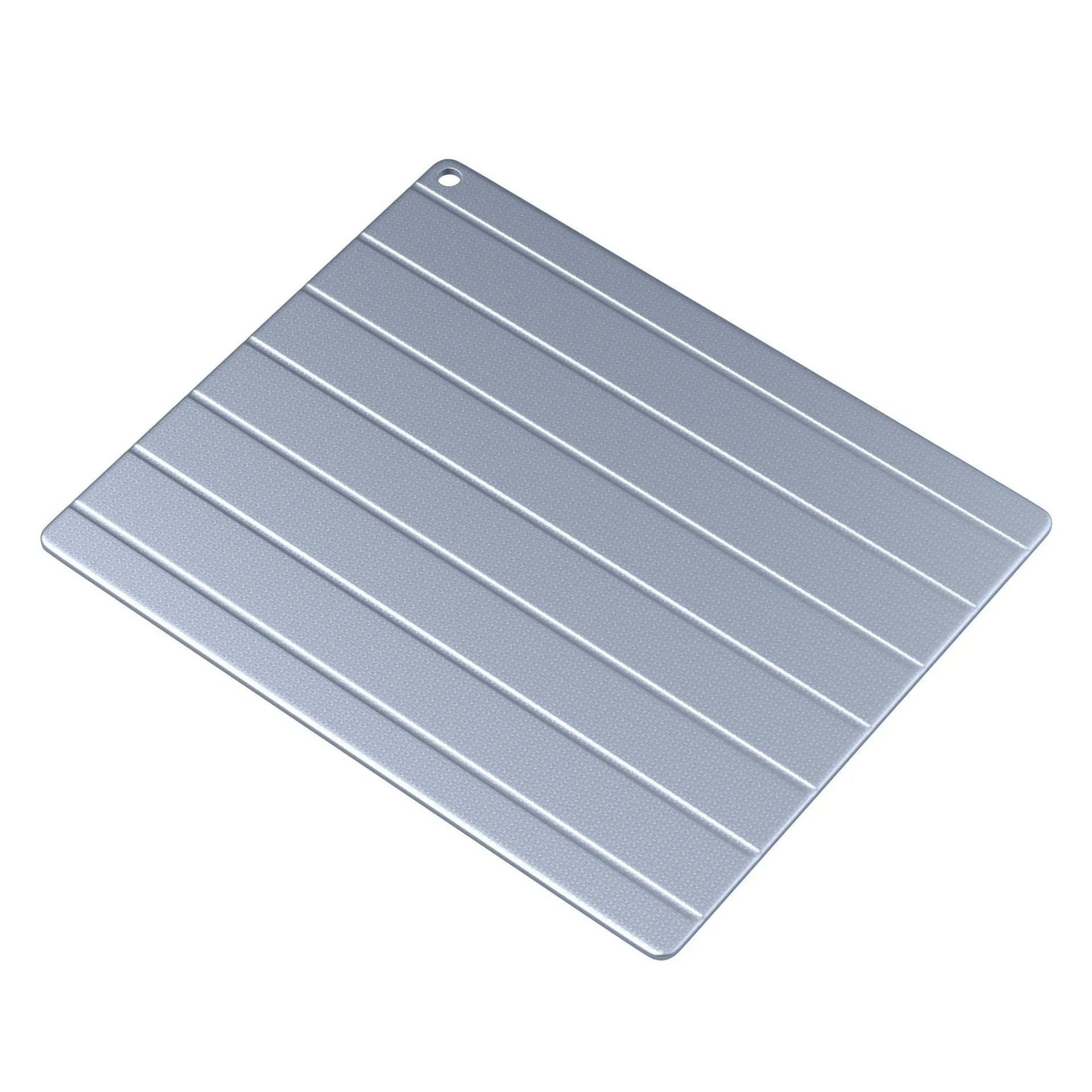Aluminium household quick defrosting plate device with separate board and USB cable on a kitchen counter.