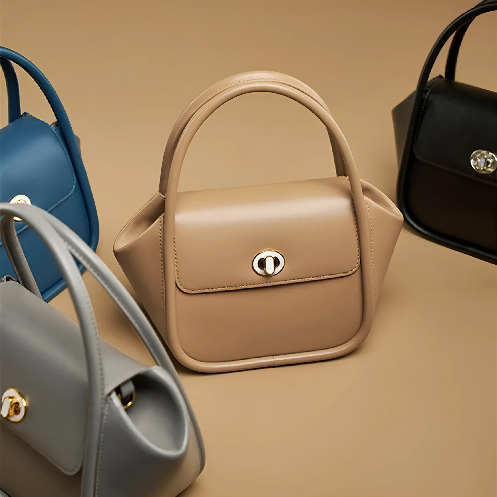 Wing-shaped women's leather handbag with latch closure and cross-body strap in available colours.