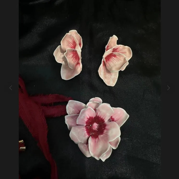 A pair of pastoral style flower stud earrings with an oil-spot glaze finish in an alloy setting.