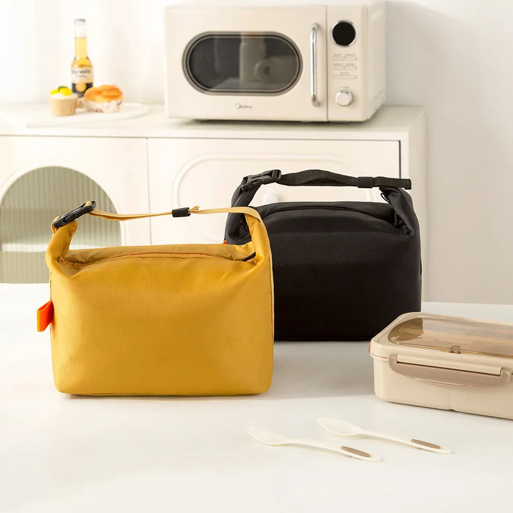 Japanese style insulated lunch bag in Oxford cloth with wide opening for food storage.