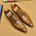 Men's black and brown leather loafers with alligator pattern and a horsebit buckle on a low rubber sole.